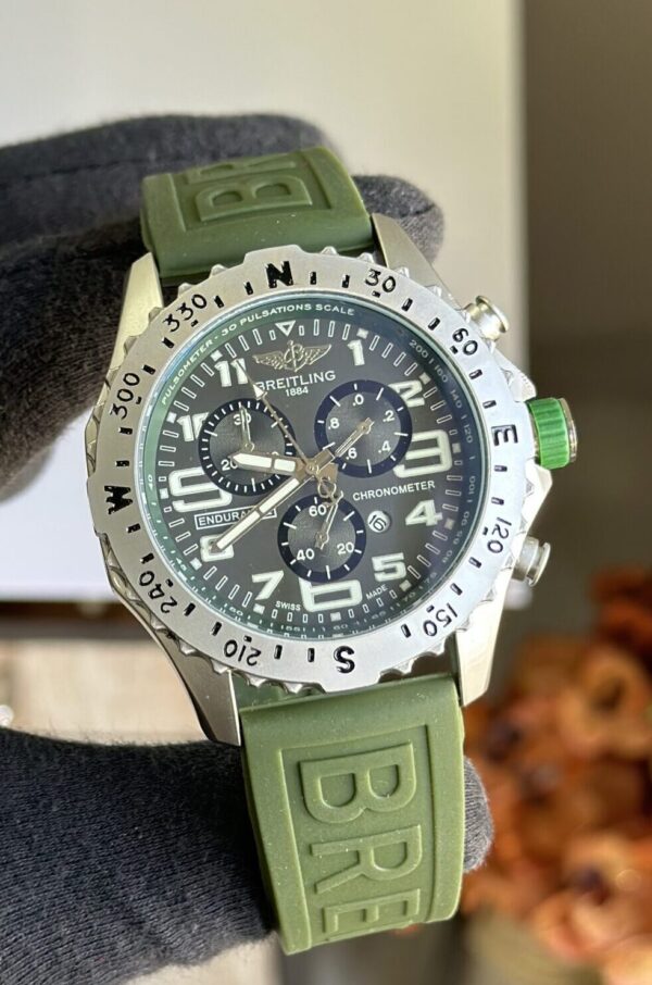 A beautiful and affordable Olive-Green Breitling casual wristwatch featuring a unique large metal dial and a sporty loop strap. Comes with a free box and cufflinks.